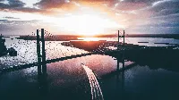 Beautiful sunset sea side 4k desktop wallpaper with bridge