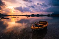 Wooden rowboat in lake 4k desktop wallpaper beautiful sunset